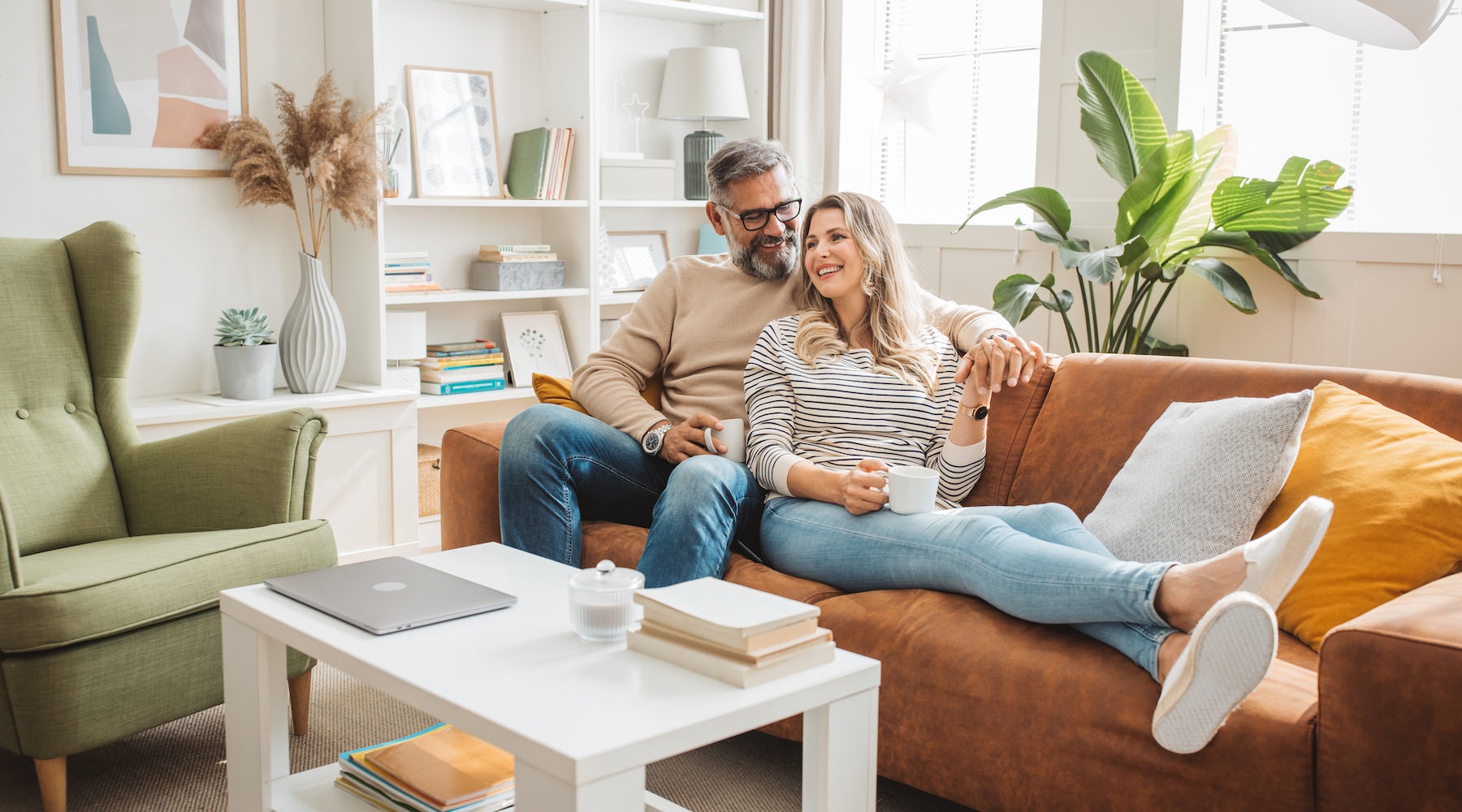 Lifestyle Couple relaxing in a well lit living room